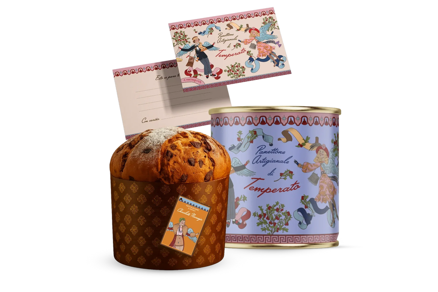 Un panettone de Temperato junto a su lata de colección y las dos postales ilustradas